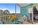 Screened lanai with outdoor seating and a view of lush tropical foliage at 1401 S Mccall Rd # 107B, Englewood, FL 34223