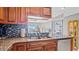 Kitchen with granite countertops, wood cabinets, and stainless steel appliances at 1401 S Mccall Rd # 107B, Englewood, FL 34223