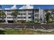 Condo building with parking and landscaping at 1401 S Mccall Rd # 107B, Englewood, FL 34223