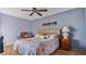 Bedroom with a floral comforter and ceiling fan at 1401 S Mccall Rd # 107B, Englewood, FL 34223