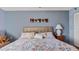 Bedroom with a floral comforter and ceiling fan at 1401 S Mccall Rd # 107B, Englewood, FL 34223