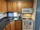 Kitchen with wood cabinets, corner sink, and stove at 200 Roma Rd, Venice, FL 34285