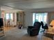 Living room with a blue recliner and view into the kitchen at 200 Roma Rd, Venice, FL 34285