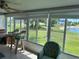 Sunroom with pond view and wicker chairs at 200 Roma Rd, Venice, FL 34285