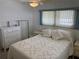 Bedroom with double bed, dresser, and ceiling fan at 200 Roma Rd, Venice, FL 34285