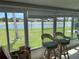 Bright sunroom with lake view and wicker chairs at 200 Roma Rd, Venice, FL 34285