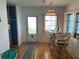 Bright dining area with glass-top table and wicker bar stools at 200 Roma Rd, Venice, FL 34285