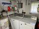 Clean laundry room with washer, dryer, and storage shelves at 200 Roma Rd, Venice, FL 34285