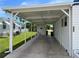 Covered carport with concrete flooring providing shade and parking at 200 Roma Rd, Venice, FL 34285