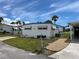 Front view of a charming mobile home with a well-kept lawn at 200 Roma Rd, Venice, FL 34285