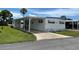 White mobile home with carport and landscaping at 200 Roma Rd, Venice, FL 34285