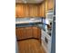Efficient kitchen with ample wood cabinets and corner sink at 200 Roma Rd, Venice, FL 34285