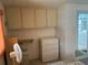 Bedroom with built-in cabinets and adjacent bathroom at 200 Roma Rd, Venice, FL 34285