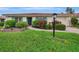 Charming ranch home with a well-manicured lawn and walkway at 5103 Greencroft Rd, Sarasota, FL 34235