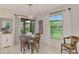 Bright dining area with a wooden table and chairs, near sliding doors to patio at 5103 Greencroft Rd, Sarasota, FL 34235