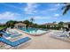 Relaxing community pool with lounge chairs at 5103 Greencroft Rd # 24, Sarasota, FL 34235