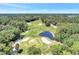 Aerial view showing a section of the golf course with sand traps and a pond at 5103 Greencroft Rd, Sarasota, FL 34235