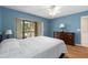 Light blue bedroom with double bed and access to lanai at 410 Cerromar S Cir # 242, Venice, FL 34293