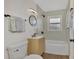 Updated bathroom with a light green accent wall and modern vanity at 1757 Mova St, Sarasota, FL 34231