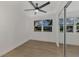 Well-lit bedroom featuring a ceiling fan, large window, and mirrored closet at 1757 Mova St, Sarasota, FL 34231