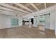 Open concept dining room with kitchen view and exposed wood beams at 1757 Mova St, Sarasota, FL 34231