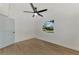 Bright bedroom with ceiling fan and light wood laminate flooring at 1757 Mova St, Sarasota, FL 34231