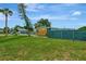 Updated home with a fenced yard, modern wood siding, and lush green lawn at 1757 Mova St, Sarasota, FL 34231