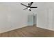 Bright bedroom with ceiling fan, wood-look floors, and mirrored closet at 1757 Mova St, Sarasota, FL 34231