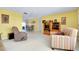 Living room with a large TV, seating area, and access to dining area at 475 Circlewood Dr # O18, Venice, FL 34293