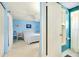 Blue bedroom with double bed and access to bathroom at 475 Circlewood Dr # O18, Venice, FL 34293