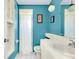 Bathroom with shower, white vanity, and blue walls at 475 Circlewood Dr # O18, Venice, FL 34293