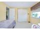 Small bedroom with a twin bed and ample closet space at 475 Circlewood Dr # O18, Venice, FL 34293