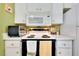 White cabinets and black stove top in this bright kitchen at 475 Circlewood Dr # O18, Venice, FL 34293