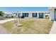 House exterior showcasing a carport and well-maintained lawn at 475 Circlewood Dr # O18, Venice, FL 34293