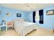 Blue bedroom with double bed, ceiling fan, and window with curtains at 475 Circlewood Dr # O18, Venice, FL 34293