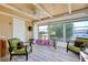 Bright sunroom with comfy seating and view of backyard at 475 Circlewood Dr # O18, Venice, FL 34293