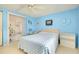 Light blue bedroom with a comfortable bed and shelving at 475 Circlewood Dr # O18, Venice, FL 34293