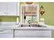 Kitchen features a double sink and pass through to adjoining dining area at 475 Circlewood Dr # O18, Venice, FL 34293