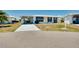 Aerial view of a single-story house with a driveway and carport at 475 Circlewood Dr # O18, Venice, FL 34293