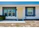 Front view of a single-story house with a yellow door and blue accents at 475 Circlewood Dr # O18, Venice, FL 34293