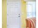 White front door with six panels and brushed nickel hardware at 475 Circlewood Dr # O18, Venice, FL 34293