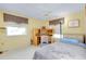 Bedroom with a twin bed, desk, and window seating at 475 Circlewood Dr # O18, Venice, FL 34293