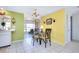 Dining area with glass table and chairs, open to kitchen and living room at 475 Circlewood Dr # O18, Venice, FL 34293