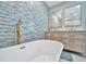 Bathroom with soaking tub, double vanity and mosaic tile at 5832 Garfield Rd, Venice, FL 34293