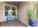 Front porch with two rocking chairs, a large potted plant, and a welcome mat at 12000 Tapestry Ln, Venice, FL 34293