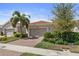 Front view of the house with a driveway and landscaping at 12000 Tapestry Ln, Venice, FL 34293