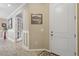Bright entryway with tile flooring, white door and view into another room at 12000 Tapestry Ln, Venice, FL 34293