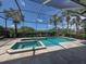Relaxing screened pool and spa with a view of lush landscaping at 117 Savona Way, North Venice, FL 34275