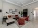 Spacious living area with sectional sofa, two accent chairs, and large TV at 117 Savona Way, North Venice, FL 34275