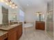 Bathroom with granite vanity, soaking tub, and shower at 117 Savona Way, North Venice, FL 34275